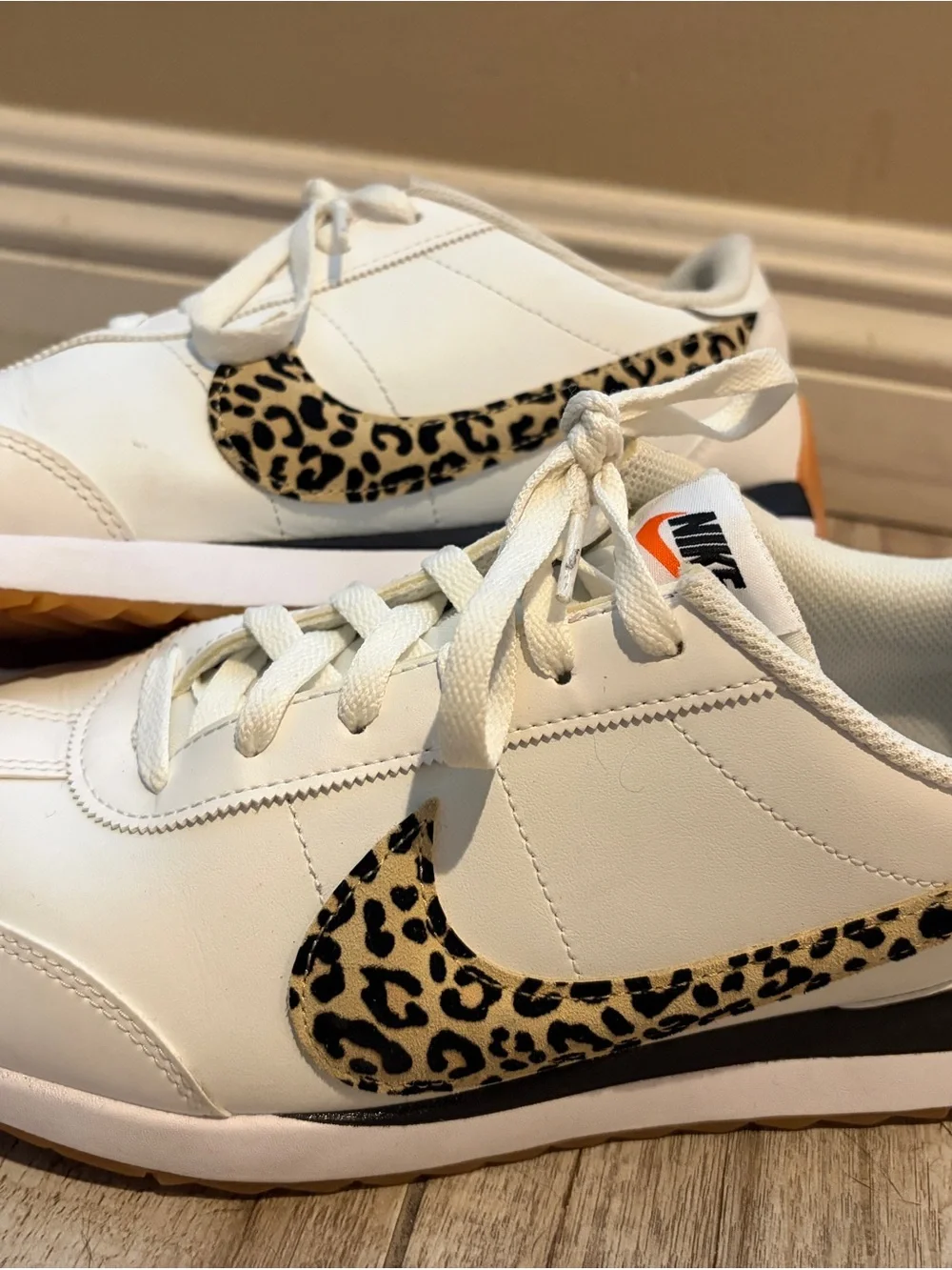 Nike Women's White Sneakers with Leopard Swoosh and Orange Heel Tab